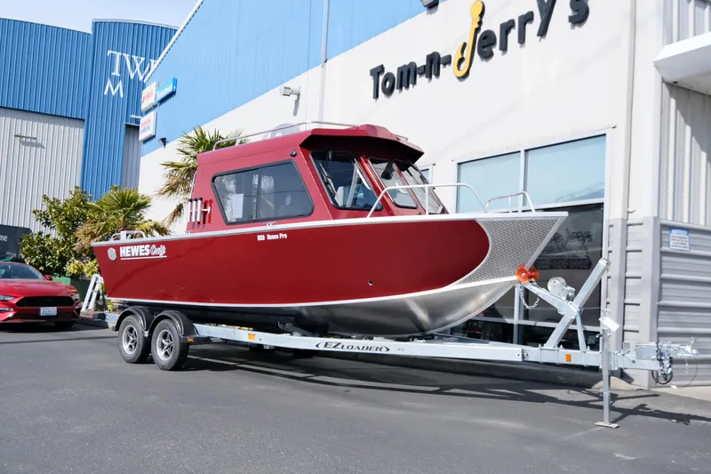 The Image of 2024 Hewescraft 220 Ocean Pro ET HT boat on trailer outside Tom-n-Jerry's store. - 0