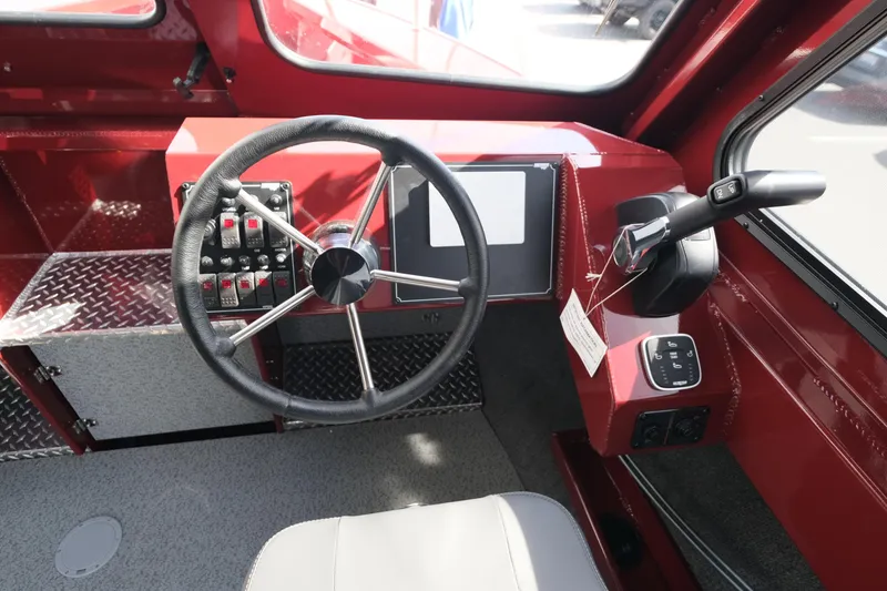 Slide: The Image of 2024 Hewescraft 220 Ocean Pro ET HT boat helm with steering wheel and control panel. - 12