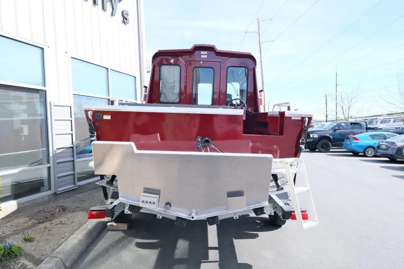 Slide: The Image of 2024 Hewescraft 220 Ocean Pro ET HT boat, rear view, parked outside dealership. - 2