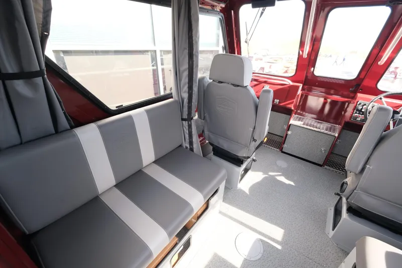 Slide: The Image of Interior of 2024 Hewescraft 220 Ocean Pro ET HT, featuring seating and helm station. - 9