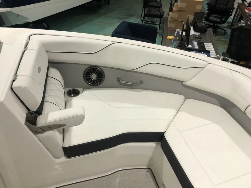 Slide: The Image of 2024 Regal LS2 boat interior with white seating and speaker. - 6