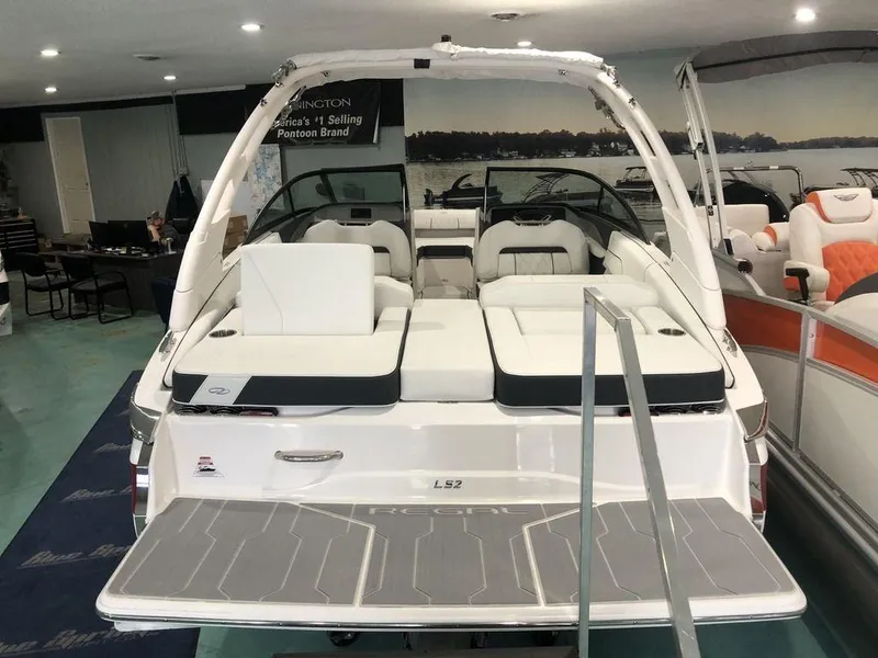 Slide: The Image of 2024 Regal LS2 boat interior with seating, displayed in showroom. - 9