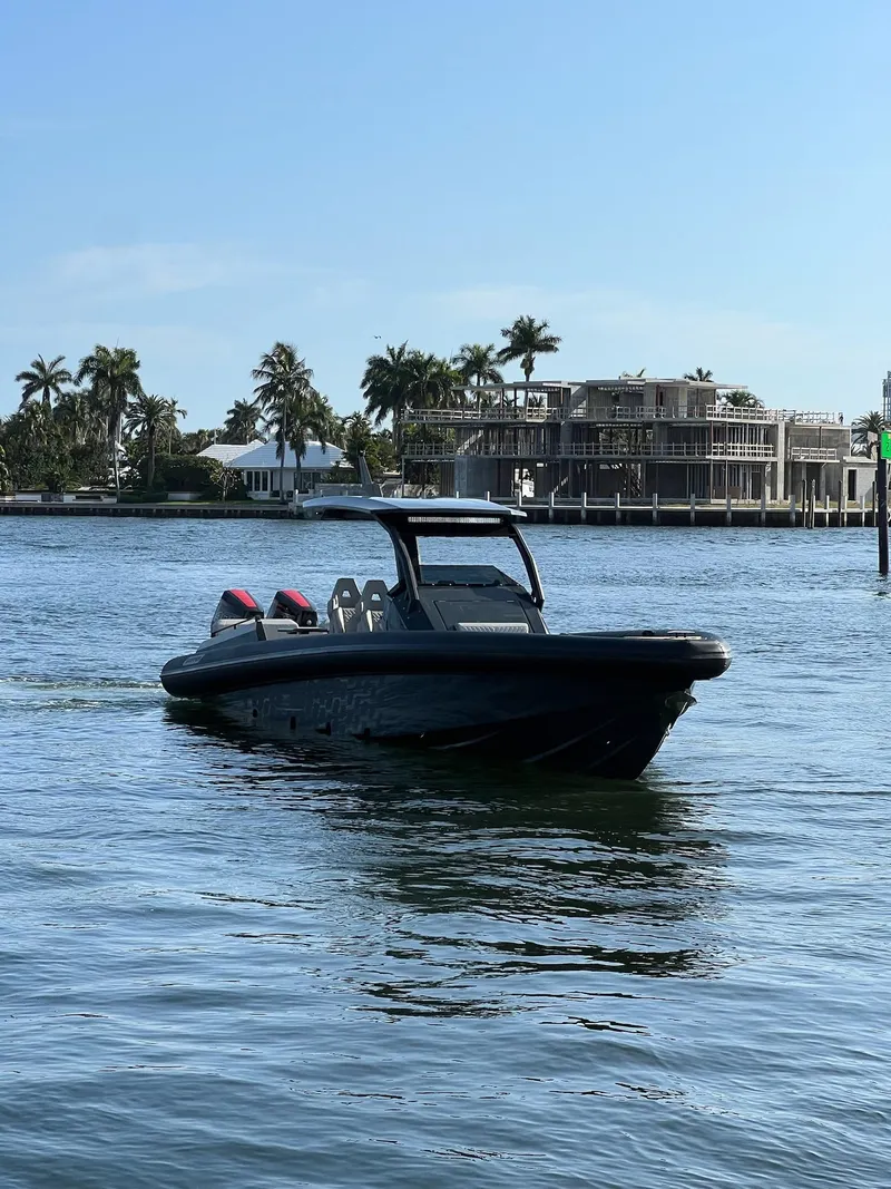Slide: The Image of 2024 Skipper-BSK 38 boat cruising on a sunny day near waterfront homes. - 3