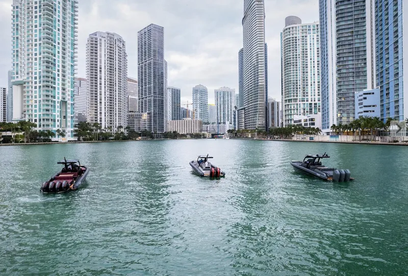 Slide: The Image of Three Skipper-BSK 38 boats in a city harbor with skyscrapers, 2024 model. - 9