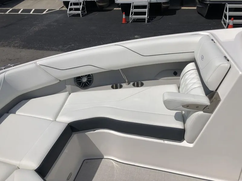 Slide: The Image of 2024 Regal LS4 boat interior with white seating and cup holders. - 7