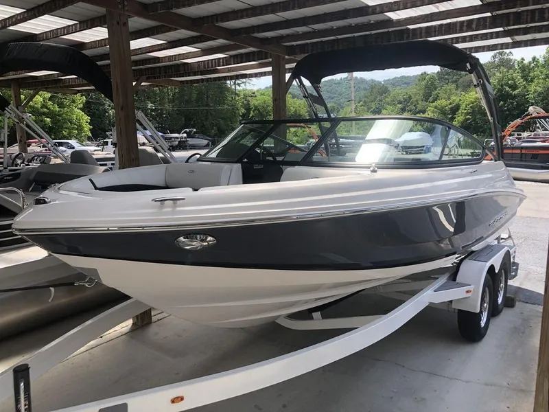 The Image of 2025 Regal 2000 ES boat on trailer under shelter, sleek design, ready for adventure. - 1