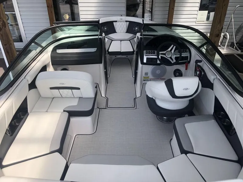 Slide: The Image of Interior of 2025 Regal 2000 ES boat with modern seating and steering wheel. - 4