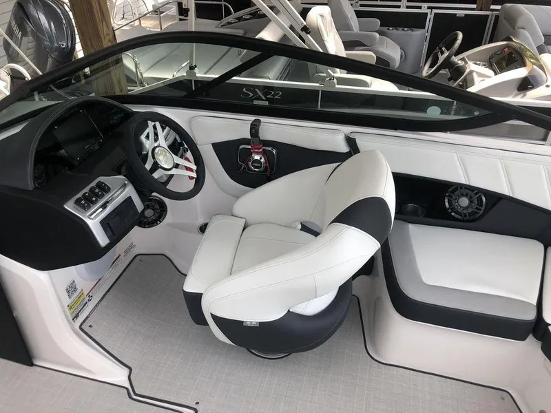 Slide: The Image of Interior of a 2025 Regal 2000 ES boat with modern seating and steering wheel. - 5