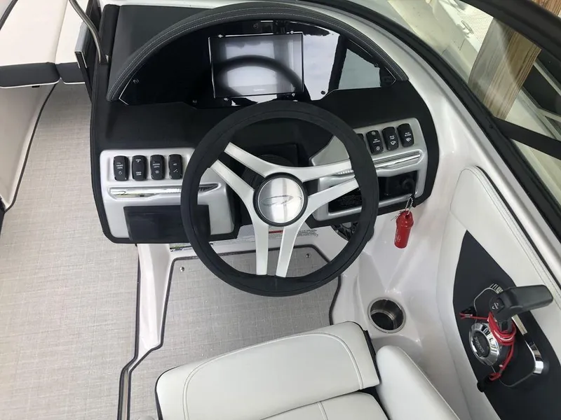 Slide: The Image of Cockpit of 2025 Regal 2000 ES boat with modern steering and controls. - 6