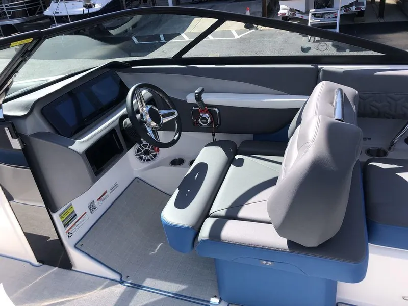 Slide: The Image of 2025 Regal LS2 Ultimate boat cockpit with modern steering and seating. - 2