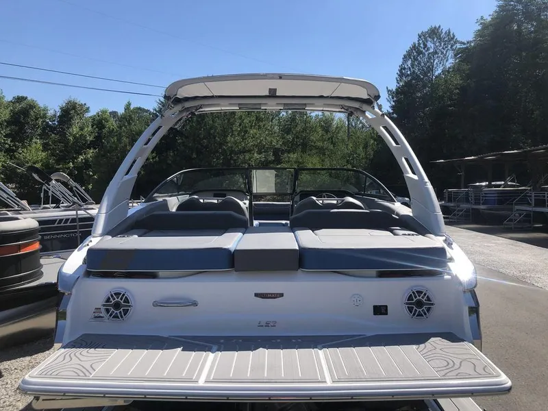 Slide: The Image of 2025 Regal LS2 Ultimate boat, rear view, in a marina setting. - 8
