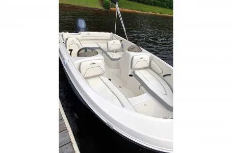 Slide: The Image of 2023 Stingray 172SC boat with white interior on a lake. - 2
