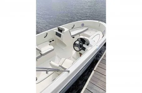 Slide: The Image of 2023 Stingray 172SC boat docked by the water. - 7