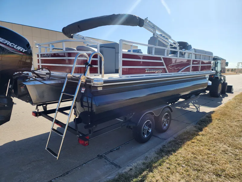Slide: The Image of 2024 Ranger Reata 220FC pontoon boat on a trailer with a ladder and Mercury outboard motor. - 3