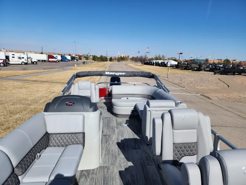 Slide: The Image of 2024 Ranger Reata 220FC pontoon boat with spacious seating and modern design. - 5