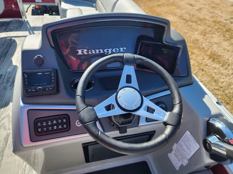Slide: The Image of 2024 Ranger Reata 220FC boat dashboard with steering wheel and control panel. - 6
