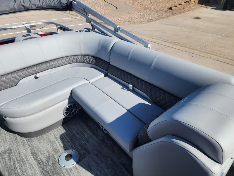 Slide: The Image of 2024 Ranger Reata 220FC boat with luxurious gray seating and modern design. - 7