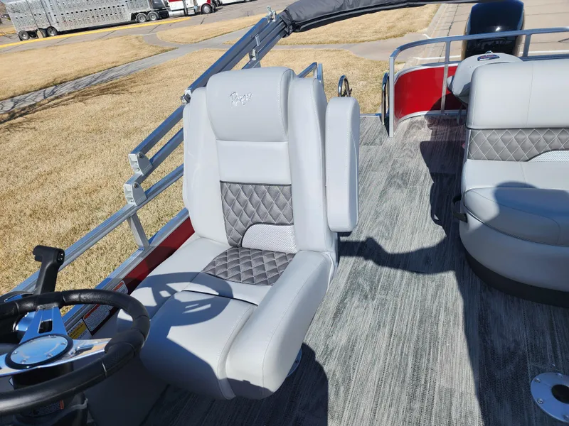 Slide: The Image of 2024 Ranger Reata 220FC boat interior with gray captain's chair and steering wheel. - 8