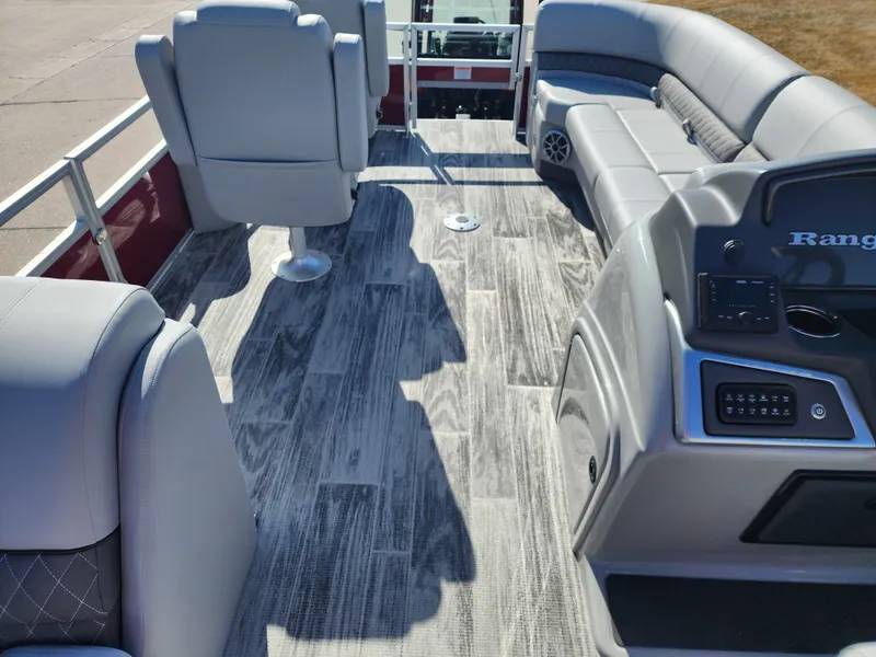 Slide: The Image of 2024 Ranger Reata 220FC boat interior with gray seating and wood-style flooring. - 9