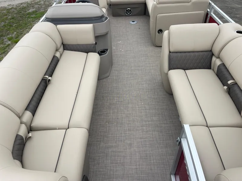Slide: The Image of 2024 Sun Tracker Party Barge 20 DLX interior with beige seating and gray accents. - 2