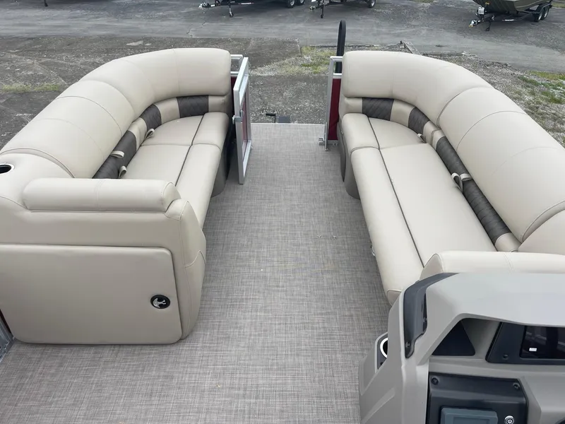 Slide: The Image of 2024 Sun Tracker Party Barge 20 DLX interior with beige seating and spacious layout. - 4
