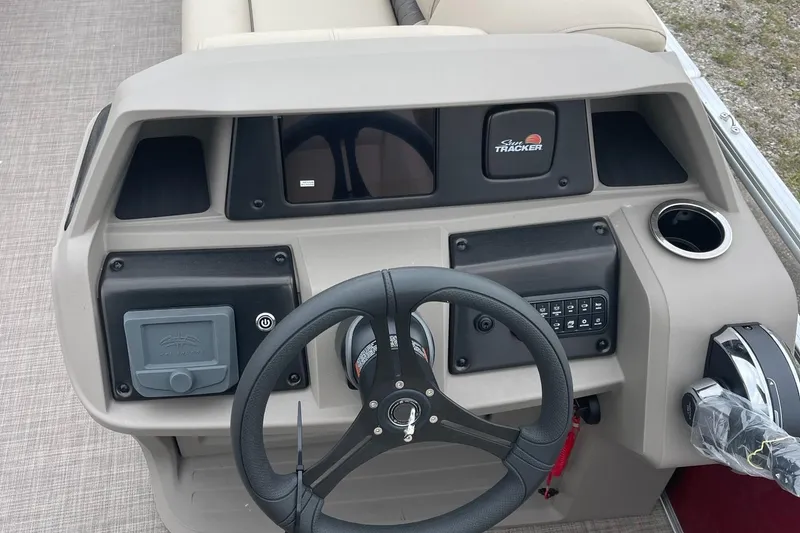 Slide: The Image of 2024 Sun Tracker Party Barge 20 DLX dashboard with steering wheel and control panel. - 7