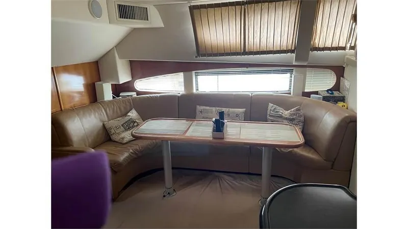 Slide: The Image of Interior of 2002 Carver 346 Motor Yacht with leather seating and dining table. - 10