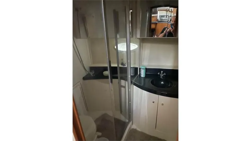 Slide: The Image of 2002 Carver 346 Motor Yacht bathroom with shower, sink, and mirror. - 11