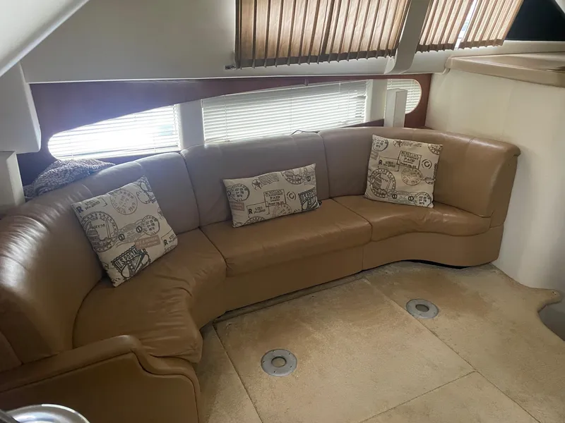 Slide: The Image of Interior of 2002 Carver 346 Motor Yacht with leather sectional sofa and decorative pillows. - 15
