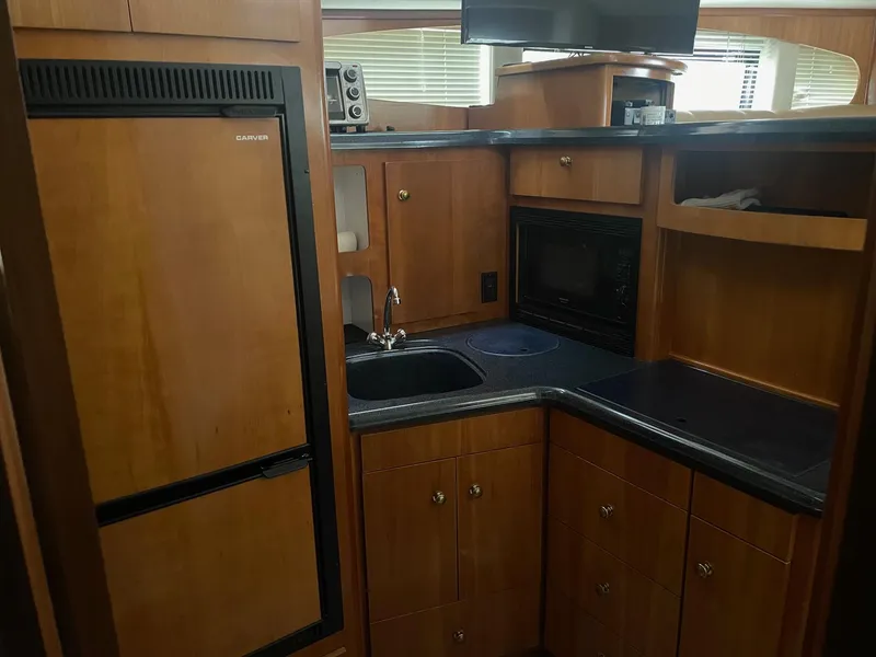 Slide: The Image of 2002 Carver 346 Motor Yacht kitchen with wood cabinetry and modern appliances. - 18