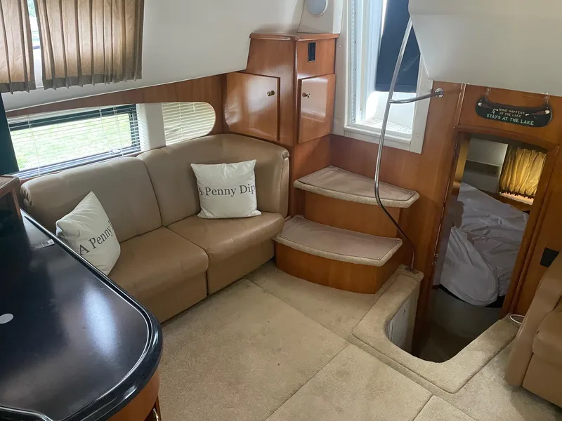 Slide: The Image of Interior of 2002 Carver 346 Motor Yacht with beige seating and wooden cabinetry. - 19
