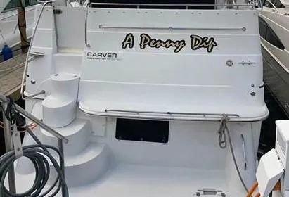 Slide: The Image of Rear view of 2002 Carver 346 Motor Yacht named A Penny Dip docked. - 2