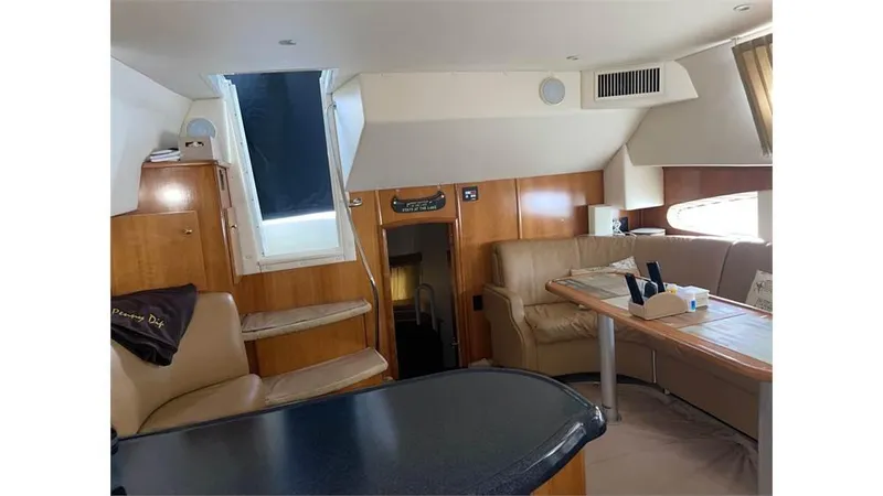 Slide: The Image of Interior of 2002 Carver 346 Motor Yacht with leather seating and wooden cabinetry. - 5