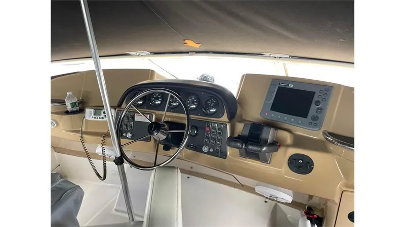 Slide: The Image of 2002 Carver 346 Motor Yacht helm with steering wheel and navigation equipment. - 8