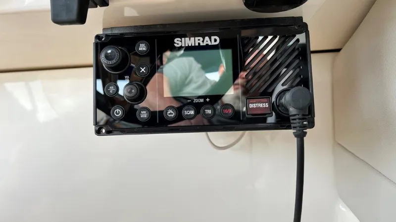 Slide: The Image of Simrad marine radio on 2022 Sea Ray SLX 280 boat dashboard. - 11