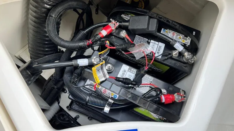 Slide: The Image of Battery compartment of 2022 Sea Ray SLX 280 boat, showing wiring and connections. - 12