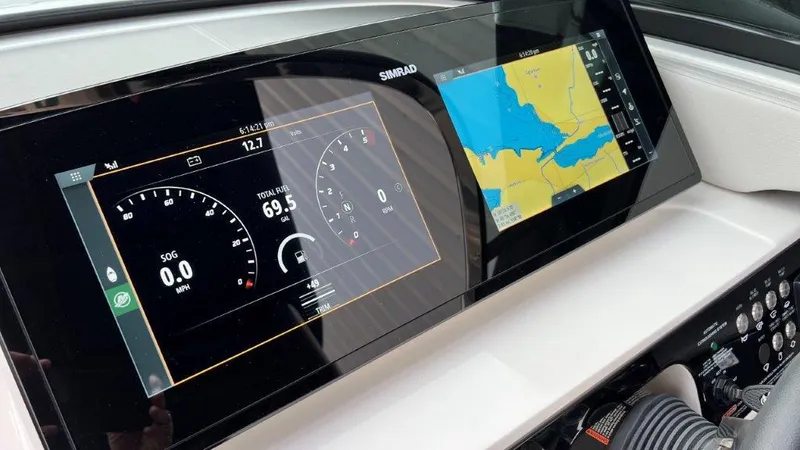 Slide: The Image of Dashboard of 2022 Sea Ray SLX 280 with navigation and fuel display. - 14