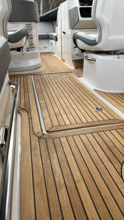 Slide: The Image of 2022 Sea Ray SLX 280 boat interior with sleek wooden flooring and modern seating. - 18
