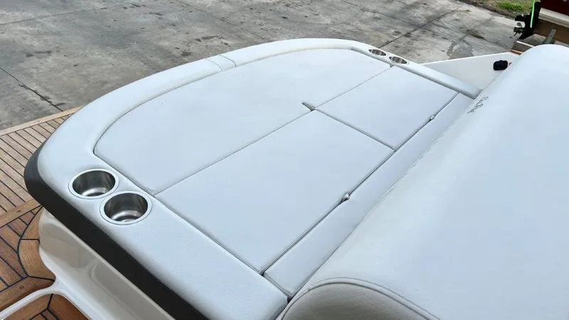 Slide: The Image of 2022 Sea Ray SLX 280 boat with white cushioned seating and cup holders on deck. - 4