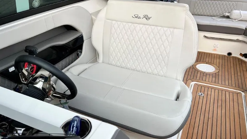 Slide: The Image of 2022 Sea Ray SLX 280 boat interior with white leather seating and wood flooring. - 7
