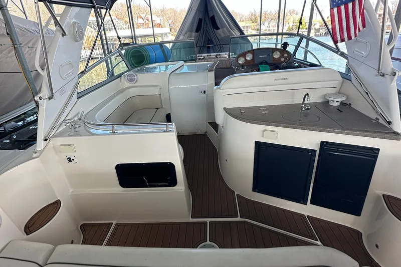 Slide: The Image of 2006 Rinker 360 Express Cruiser interior with seating and kitchenette. - 12