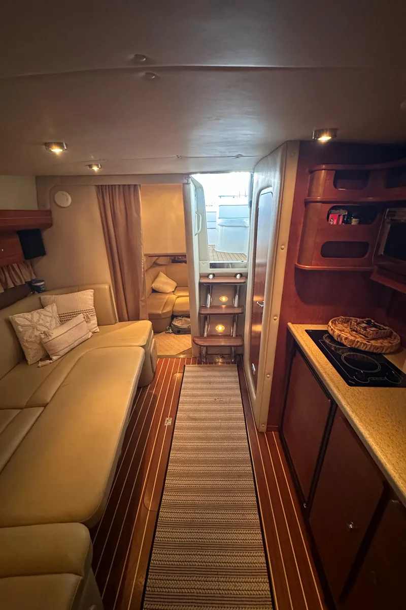 Slide: The Image of Interior of 2006 Rinker 360 Express Cruiser with cozy seating and kitchenette. - 22