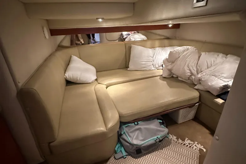 Slide: The Image of Interior cabin of a 2006 Rinker 360 Express Cruiser with beige seating and pillows. - 23