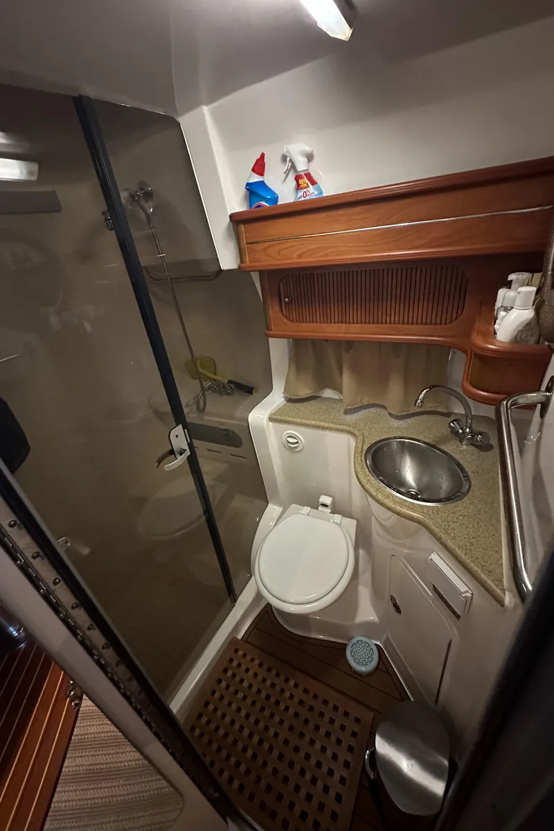Slide: The Image of 2006 Rinker 360 Express Cruiser bathroom with shower, sink, and toilet. - 26