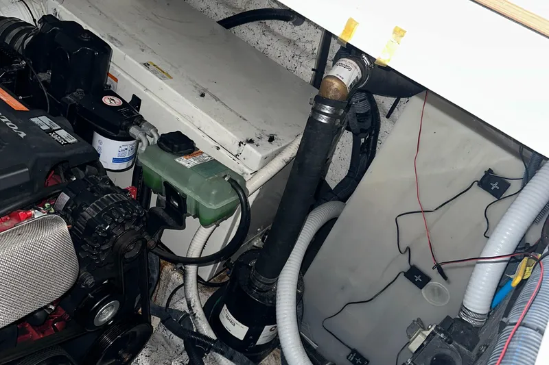 Slide: The Image of Engine compartment of a 2006 Rinker 360 Express Cruiser showing various mechanical components. - 35