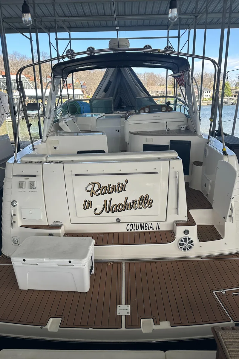 Slide: The Image of 2006 Rinker 360 Express Cruiser docked, rear view with Runnin' in Nashville text. - 4