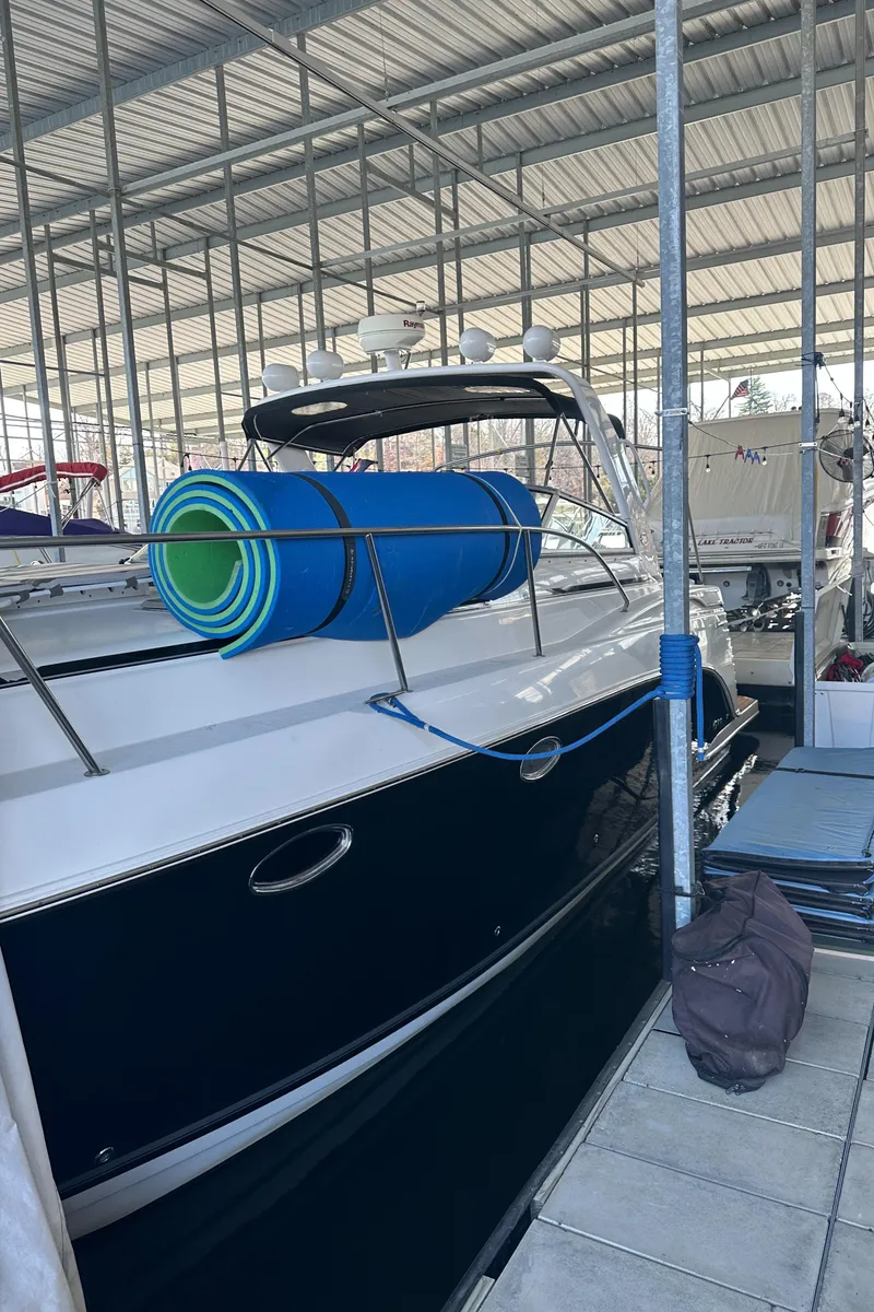 Slide: The Image of 2006 Rinker 360 Express Cruiser docked in a covered marina. - 5