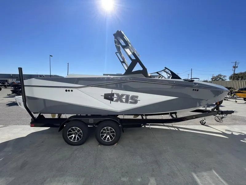 Slide: The Image of 2024 Axis T220-r boat on trailer under clear blue sky. - 13