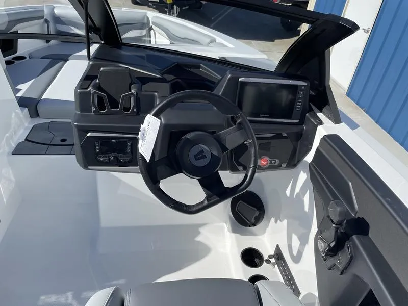 Slide: The Image of 2024 Axis T220-r boat dashboard with steering wheel and touchscreen display. - 14