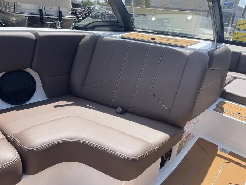 Slide: The Image of 2024 Malibu 21 LX boat interior with brown leather seating and modern design. - 14